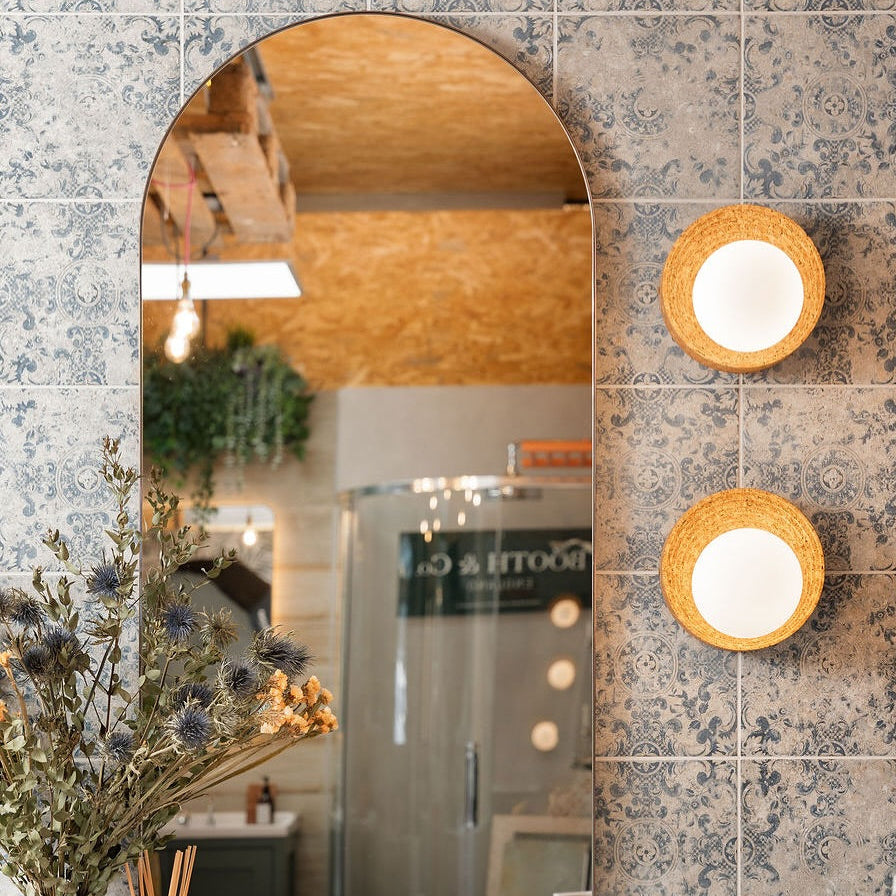 Bathroom interior with a sink, mirror, and cork wall lights.